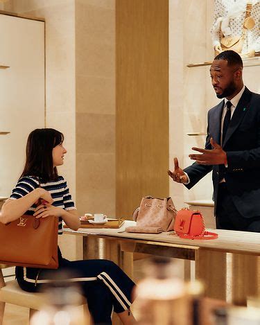 A Lancôme employee providing expert consultation to a customer in a retail environment.