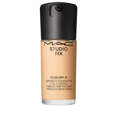 Close-up of M∙A∙C Studio Fix Fluid SPF 15 foundation being applied with a brush and sponge.