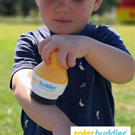 Photo of a child happily using the Solar Buddies applicator outdoors.