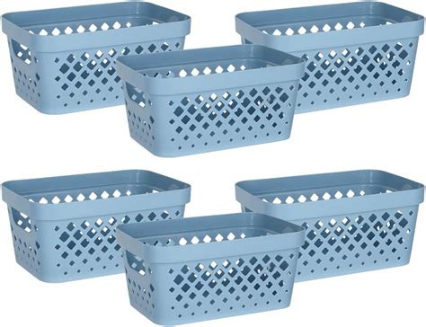 A set of stackable plastic baskets used for bathroom organization.