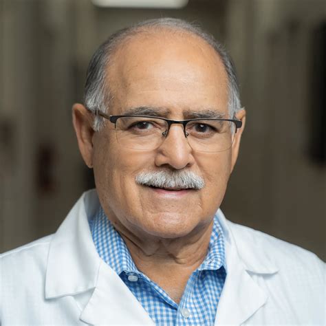 Dr. Oscar Sotelo examining a patient's skin