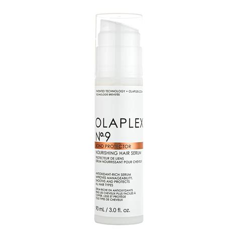 Styling hair with a blow dryer after applying Olaplex No. 9 serum