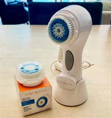 Sleek packaging and ergonomic design of the Clarisonic Aria cleansing brush with its charging stand