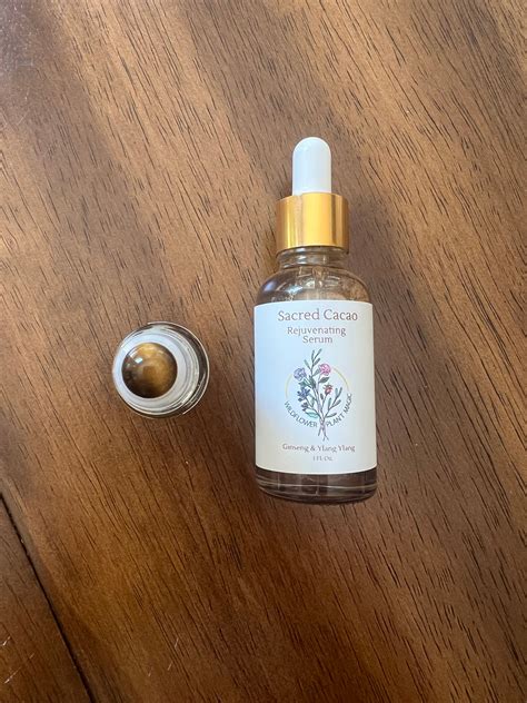 A close-up shot of the Sacred Serum bottle, with a backdrop of fresh, organic plant ingredients.