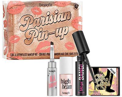 A close-up of the Benefit Cosmetics Parisian Pin-up Chic & Effortless Makeup Kit contents, highlighting the mini blush, brow product, mascara, and highlighter.