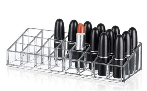 A clear acrylic spinning lipstick holder filled with various lipstick tubes.