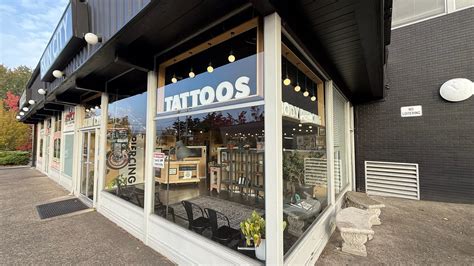 An exterior shot of the Skin City Tattoo & Body Piercing studio, showcasing a clean and modern facade.