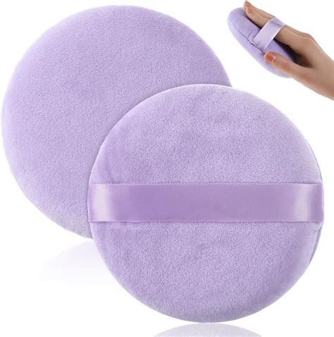 A close-up of a dual-sided powder puff, showing a soft velour side and a mesh side.