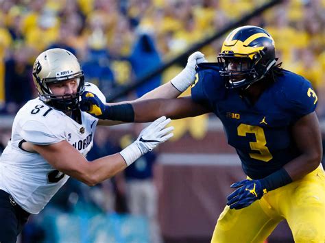 Rashan Gary making a tackle during a Michigan Wolverines game.