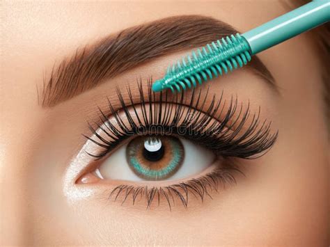 Close-up shot of the Caliray mascara wand and its application on lashes.