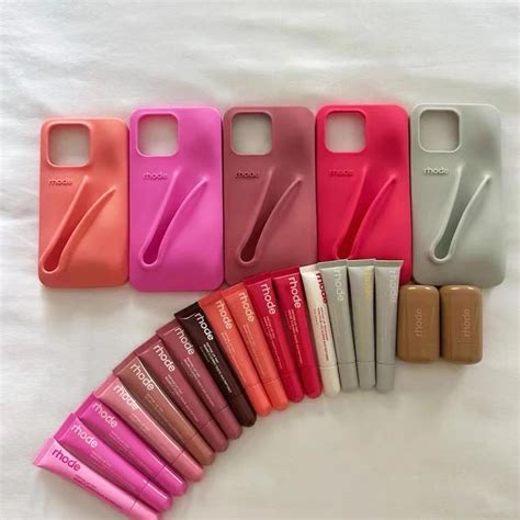Close-up of a phone case with a lipstick securely clipped into its designated holder.