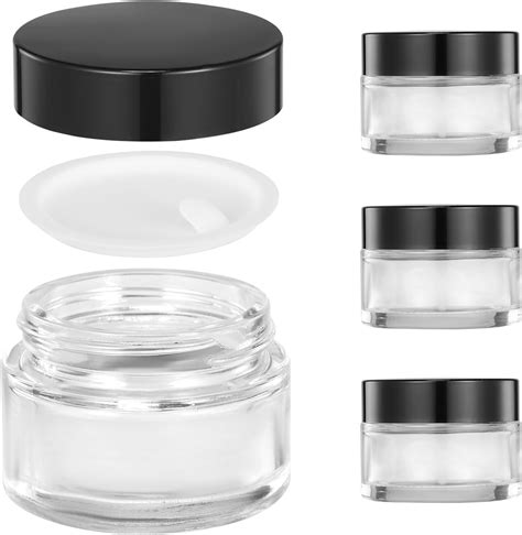 A selection of small round clear glass jars in various sizes, ideal for lip balm packaging.