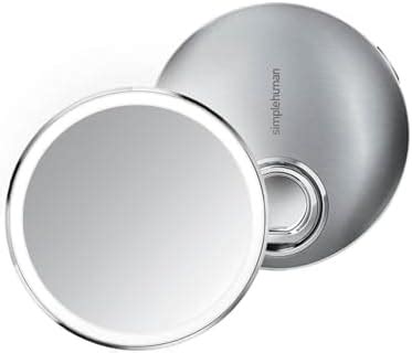 A Simplehuman wall-mounted makeup mirror with its telescopic arm extended