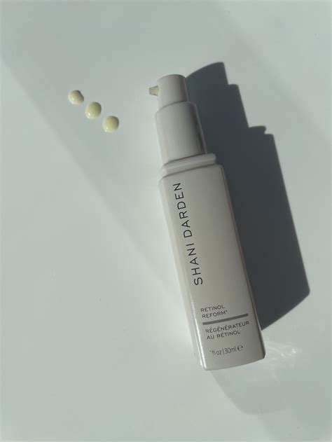 Close-up of Shani Darden's Retinol Reform serum bottle with a swatch demonstrating its texture and color.