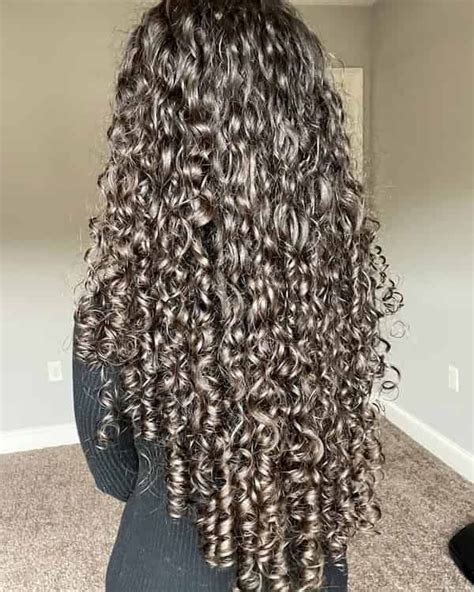 Close-up of defined, shiny curly hair that has been treated with serum.
