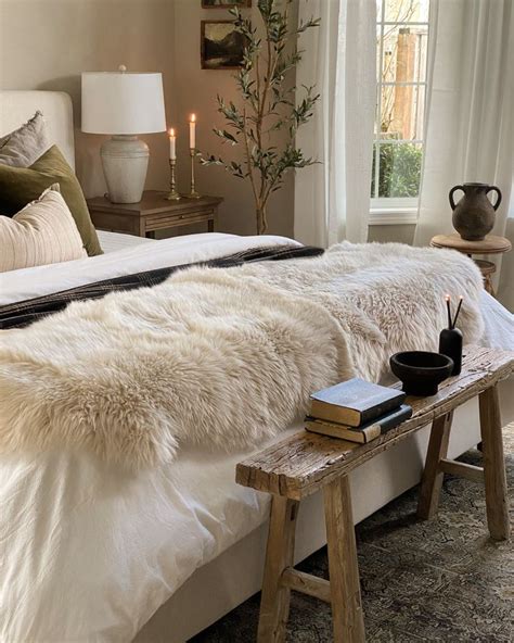 A cozy bedroom with a large sheepskin rug placed at the foot of the bed, adding texture and warmth.