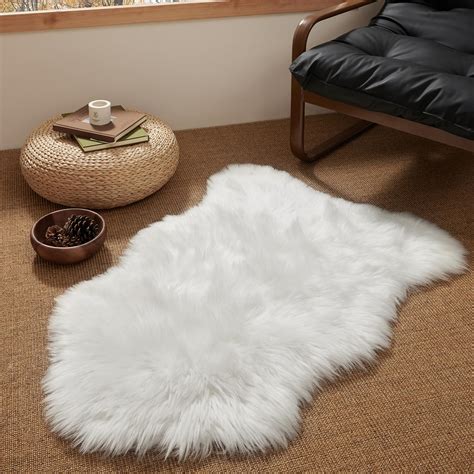 A close-up of a baby lying comfortably on a soft sheepskin rug during a professional photoshoot.