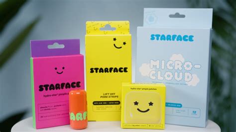 A person with Starface Glow Stars on their face, smiling in the dark