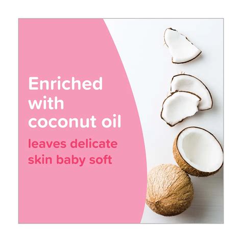 Close-up of coconut oil being applied to baby's skin.