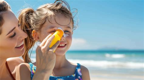 Mom applying sunscreen stick to a child's face outdoors