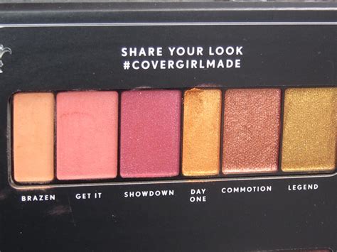 Swatches of the Covergirl Revolution Eyeshadow Palette, showcasing fiery red, gold, and cranberry shades.