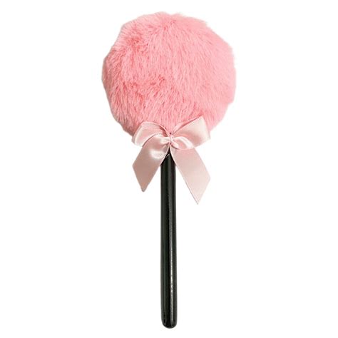 Product image of a pink lollipop-shaped powder puff with a long handle.