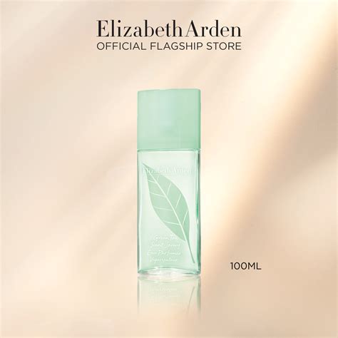 Elegant bottle of Elizabeth Arden Green Tea Scent Spray surrounded by green tea leaves