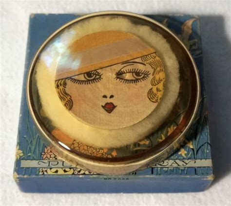 A collection of vintage compacts displaying diverse Art Deco motifs, floral patterns, and animal imagery, highlighting the artistic craftsmanship of the era.