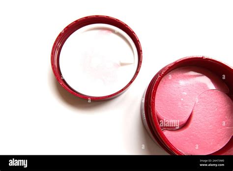 Side-by-side comparison of an eye cream jar and a package of eye patches, highlighting different application methods.