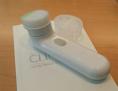 Close-up photo of the Clinique Sonic System Cleansing Brush in use.