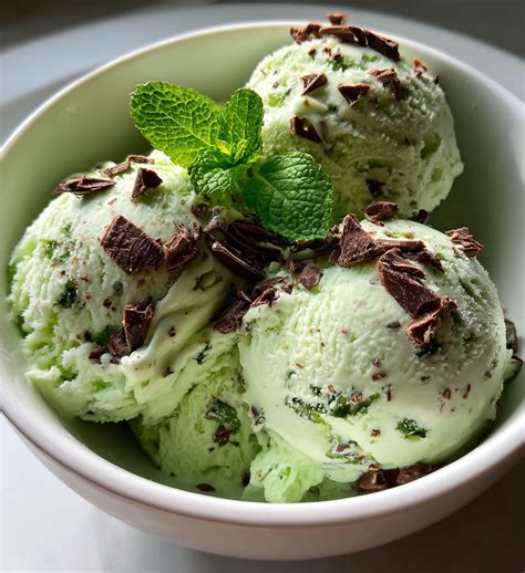 A vibrant scoop of pineapple mint ice cream with fresh mint leaves