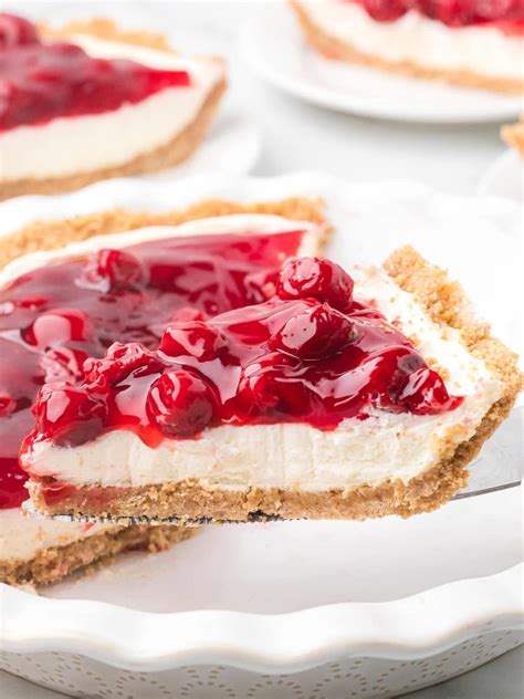 A scoop of cherry pie ice cream with visible chunks of pie crust and cherries