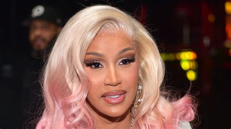 Cardi B with golden ash blonde hair, showcasing its balanced tone.