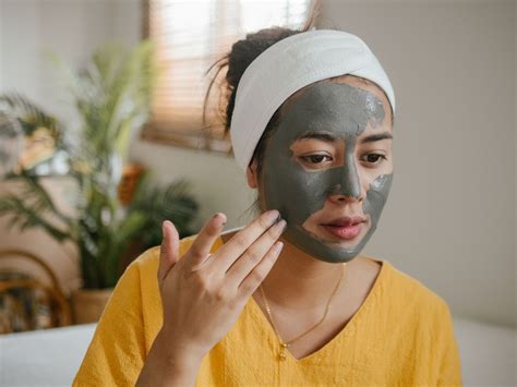 A visually appealing image of a person applying a clay mask to their face.
