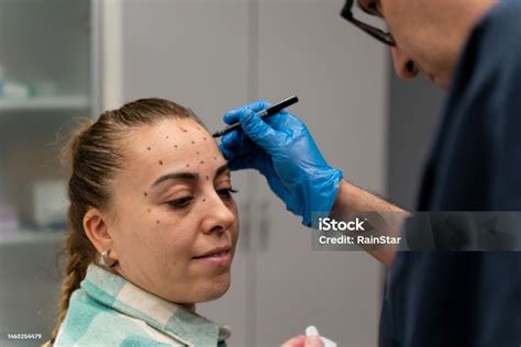 Aesthetician consulting with a client about Botox injections