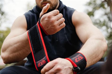 A person demonstrating the proper application of Velcro wrist wraps