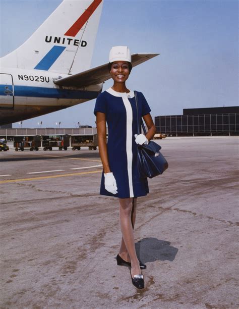 A photograph of Brenda Clinton in her vintage flight attendant uniform, highlighting the era's fashion standards.