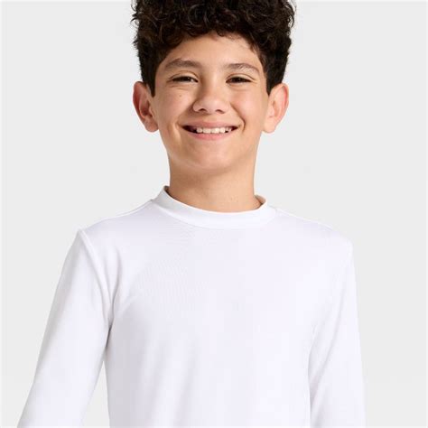 A toddler wearing a white, long-sleeved rash guard top with the Cat & Jack logo.