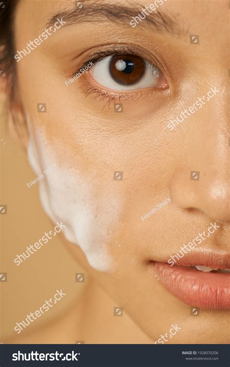 Close-up of a person's face with gentle foam on their skin, highlighting a clean and refreshed look.