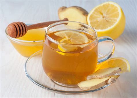 Image of a steaming mug of herbal tea with honey and lemon, symbolizing soothing warmth for a sore throat.
