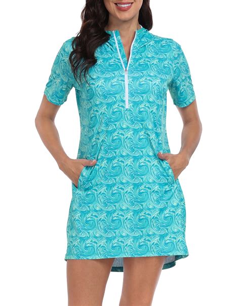 Lifestyle image of a woman wearing a short-sleeve UPF 50+ pullover dress in a sunny outdoor setting.