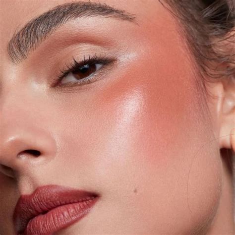 A bride with dewy skin and flushed cheeks, showcasing a natural and radiant look.