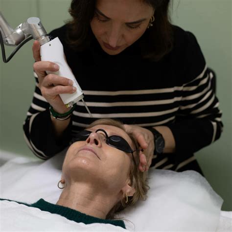 Image of a person undergoing Pico Genesis laser treatment, showing the laser device being used on the face.