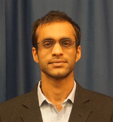 Portrait of Muhammad Mustafa Rashid, professional and academic attire.