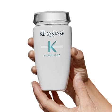 A close-up shot of the Kérastase Symbiose shampoo bottle, highlighting its elegant design and branding.