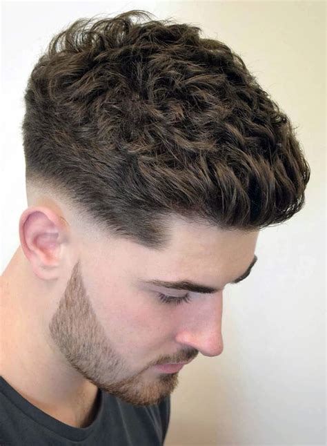 A man styling short, textured hair with a cream.