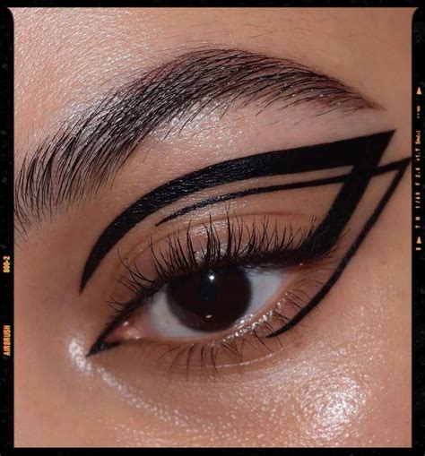 Close-up of a makeup look featuring intricate 3D graphic liner created with glue and shimmer.