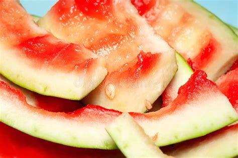 A close-up shot of watermelon rind sprinkled with chili powder and a hint of lemon juice.