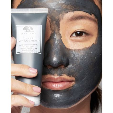 Jenifer Calle applying the Origins Clear Improvement Active Charcoal Face Mask.