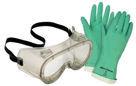 Person wearing protective gloves and goggles while working with spray foam